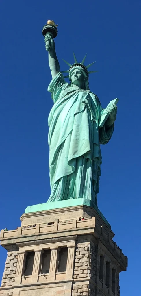 Statue of Liberty against a blue sky, symbolizing democracy and civic freedom.